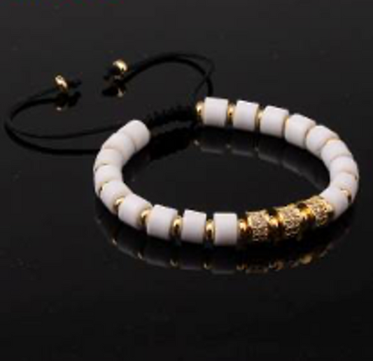 P93422 PULSERA DE îNIX BLANCO Y ACERO INOX COLOR DORADO CON CIRCONES BLANCO.
