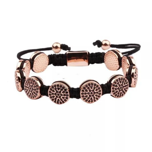 P95782 PULSERA DE îNIX CIRCULARES DORADAS CON CIRCONES NEGROS.